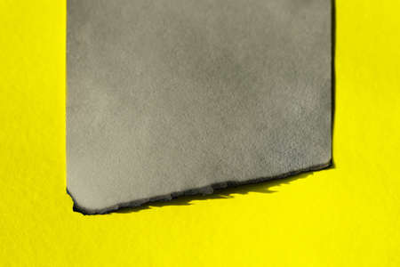 craft page with burned edge on yellow background.