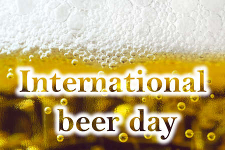 light beer with foam and inscription International beer dayの写真素材