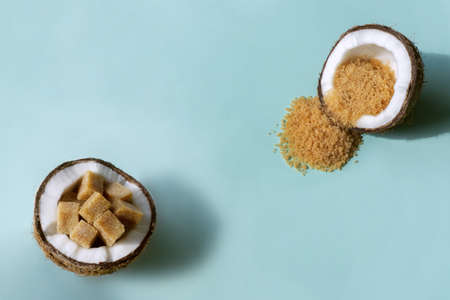chopped coconut halves with coconut sugar insideの写真素材