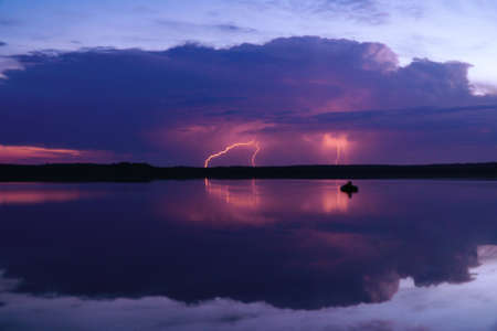 several lightning strikes during a strong thunderstorm over the lake
