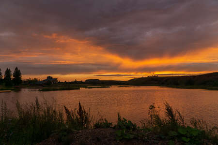 sunset over a small lake in summer in Bashkiriaの写真素材