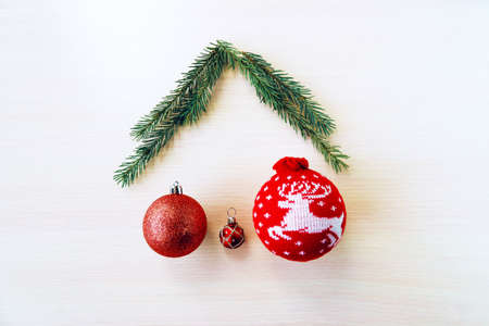 a family of christmas balls under the roof of fir branchesの写真素材