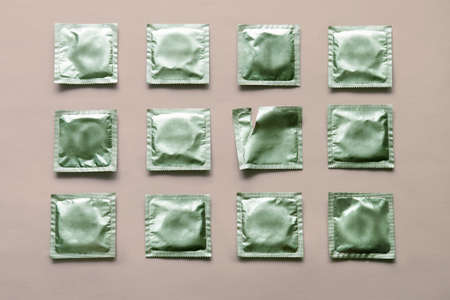 pattern of many green condoms and empty package on pink backgroundの素材 [FY310163961799]