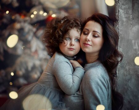 mom and daughter in a beautiful New Years studioの写真素材