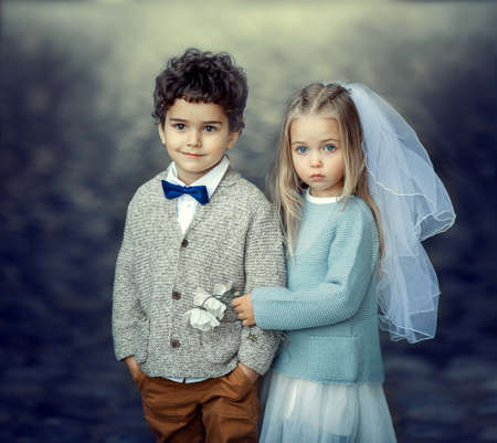boy and girl dressed as bride and groomの写真素材