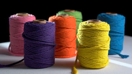 multicolored spools of thread on the table