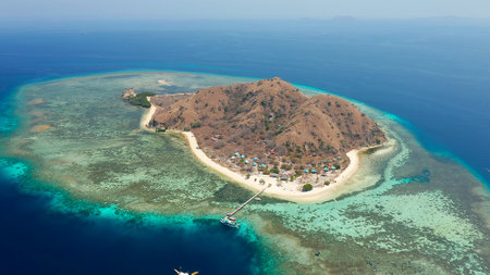 small brown island in the middle of the seaの写真素材