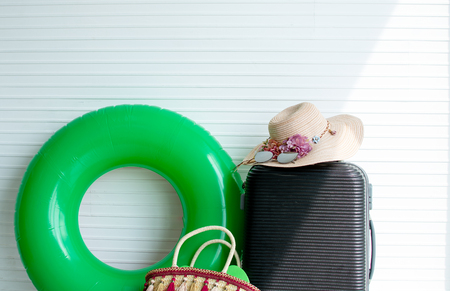 White background with luggage and woman's accessories for going to the beach in Summer timeの写真素材