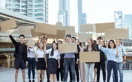 Group of protestors shouting out for human rights with blank sign