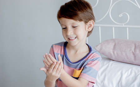 A little caucasian boy washing his hands by cleansing gel to protect virus. Health, New Normal and...