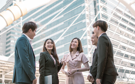 Group of business people wearing formale suit, working, talking and discussing their jobs together outdoorの写真素材