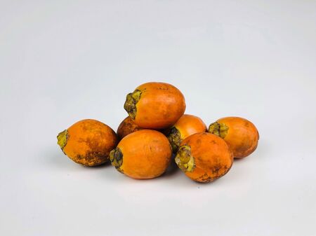 group of orange Areca nut palm fruit isolated on white backgroundの写真素材