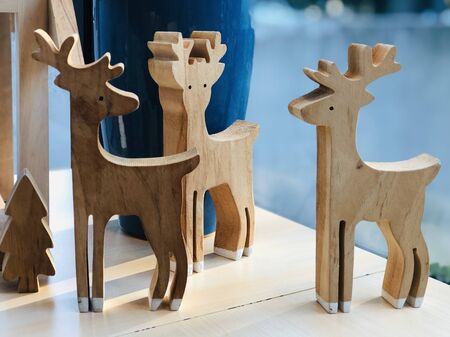 Close-up three small wooden reindeers on tableの写真素材