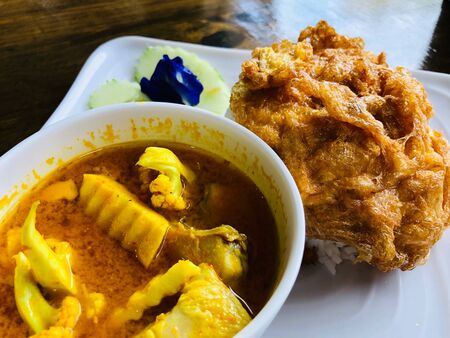 Close-up sour curry or Kaeng-Som and  fried egg: Local Thai food from Southern of Thailand