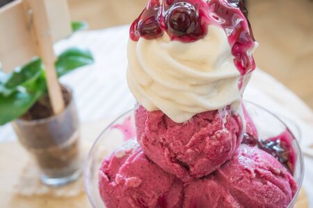 Ice-Cream blue berry with whip cream and syrup.の写真素材