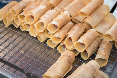 Khanom Tokyo is a thin flat pancake filled with sweet custard cream. Some have a savory filling, like pork or sausage. It is a Thai street snackの写真素材
