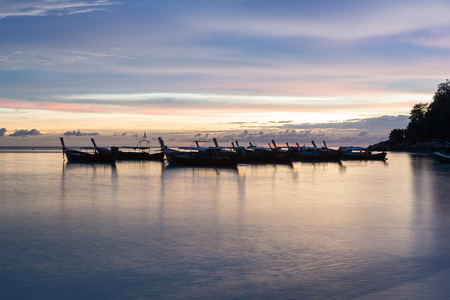 Silhouette sunset sky at pattaya beach in Koh Lipe Island.Soft focus and motion blur due to long exposure shotの写真素材