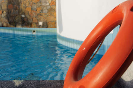 A red lifebuoy near the poolsideの写真素材