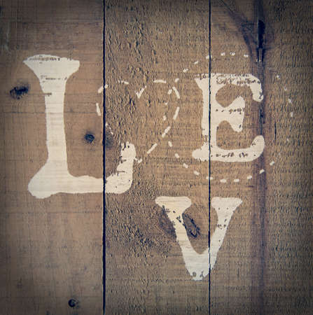 A background of wood with love text painted on it vintage styleの写真素材