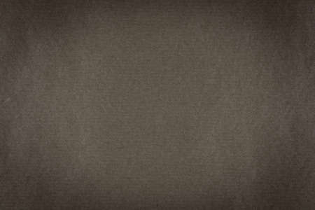 A background of dark brown paper texture with vignetteの写真素材