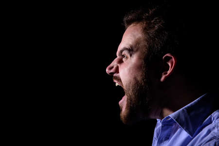 Bearded man screams into the darkの写真素材
