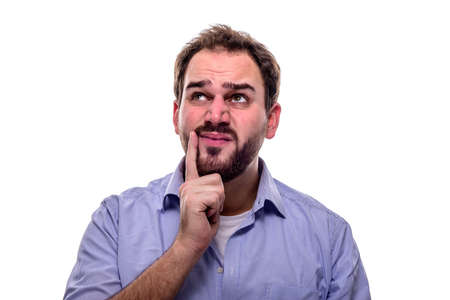 Man with questioning look in his eyes and finger on his cheek