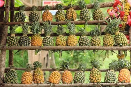 Pine apples on the shelf at the shop sidewaysの写真素材