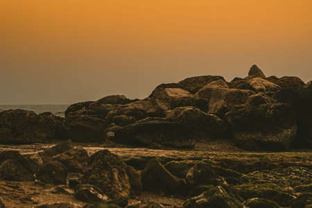 Sunset in the sea with rocksの写真素材