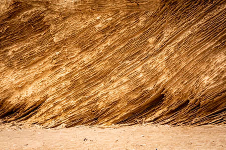 Closeup of sandstone, abstract pattern of yellow ochre sand/