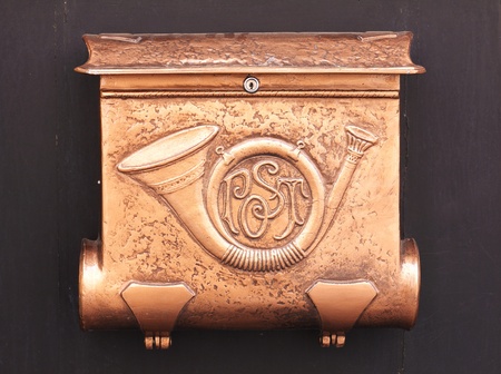 Copper mailbox with postal symbol
