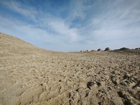 Landscape of sand dunes and blue sky with white clouds.の写真素材