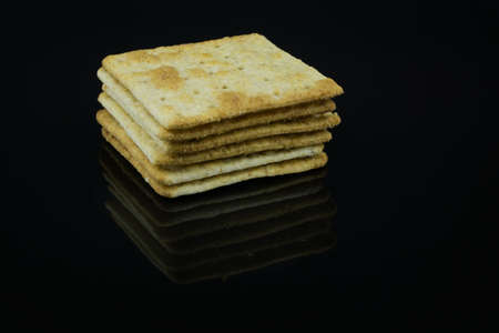 High Fibre Cream Crackers on black background