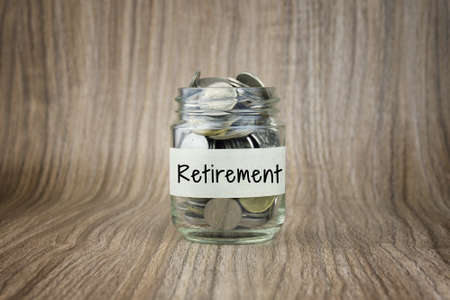 Glass jars with coins labeled Retirement. Financial Conceptualの写真素材