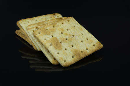 High Fibre Cream Crackers on black backgroundの写真素材