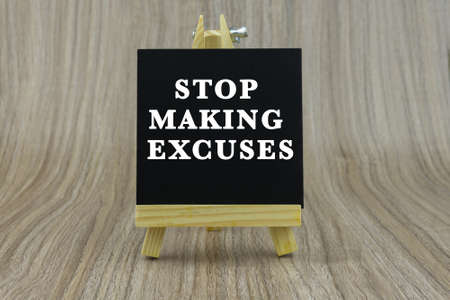 Art board, wooden easel, front view with word Stop Making Excusesの写真素材