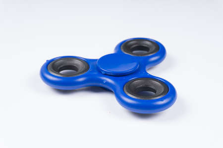 Fidget spinner stress relieving toy isolated on white background.の写真素材