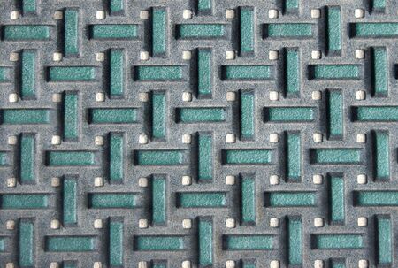 A green and gray outdoor floor mat