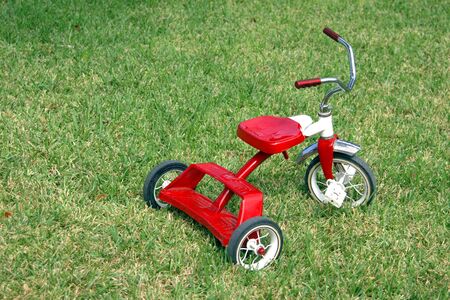 A classic red child's tricycleの写真素材