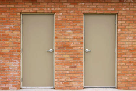 A set of doors built into a red brick wallの写真素材