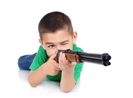 boy with toy rifle, in prone shooting position, isolated on whiteの写真素材