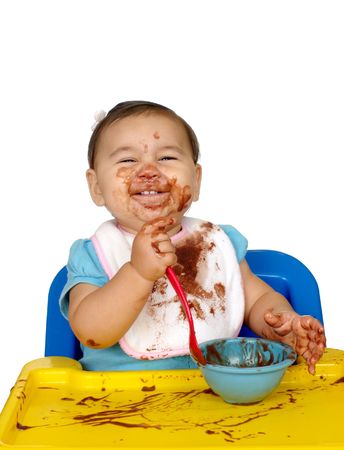 baby with chocolate pudding messy faceの写真素材