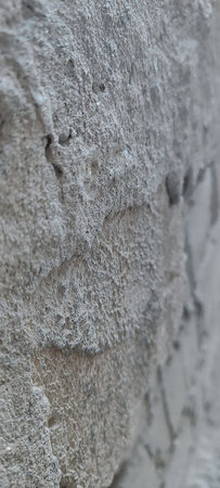 A raw concrete surface with visible pebbles and a minimalist aesthetic.