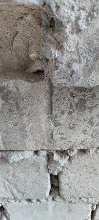 Close-up details of cracked and uneven textures on a cement surface.の写真素材