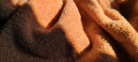 The luxurious surface of a beige towel captured in high detail, perfect for wellness and relaxation themes.â¨の写真素材