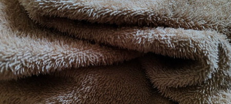 A macro shot of the intricate fibers of a beige towel, emphasizing its softness and textured appearance.â¨の写真素材