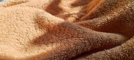 A highly detailed image of the textured surface of a beige towel, perfect for textile and home decor themes.の写真素材