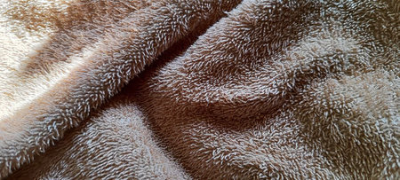 A macro image capturing the soft and plush fibers of a beige towel, suitable for relaxation and spa-related themes.の写真素材