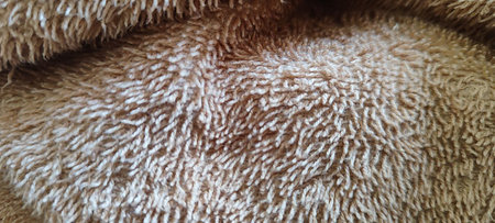 A high-quality close-up view of a soft beige towel, showcasing its textured fabric and intricate fibers.の写真素材