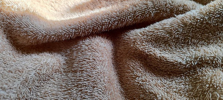 A close-up image showcasing the detailed and textured fibers of a beige towel, perfect for fabric and textile-related uses.â¨の写真素材