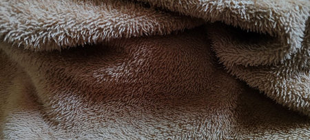 A close-up of the high-quality texture of a beige towel, ideal for themes of comfort, luxury, and home decor.â¨の写真素材